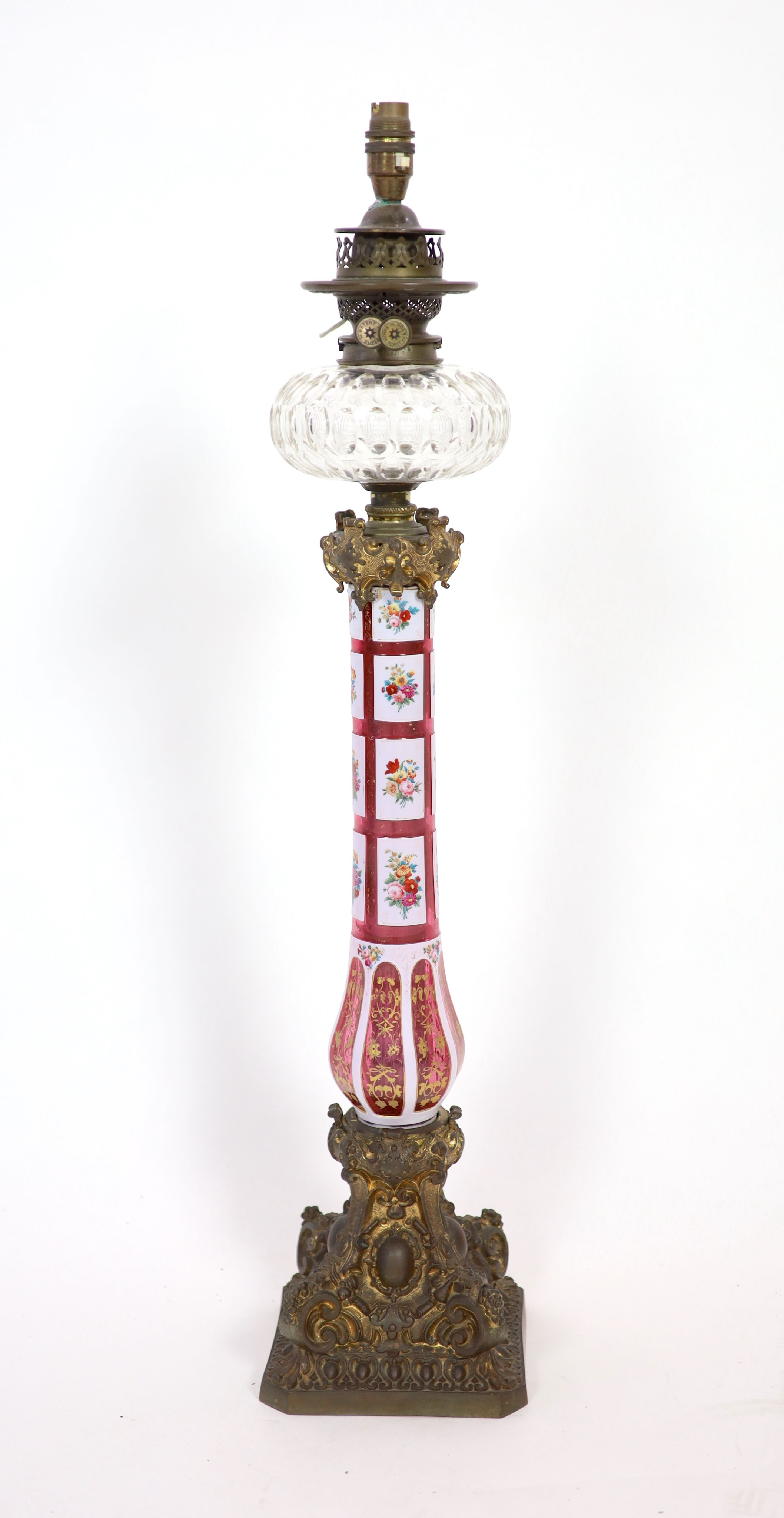 A Victorian ormolu mounted Bohemian ruby overlaid glass oil lamp, height 79cm